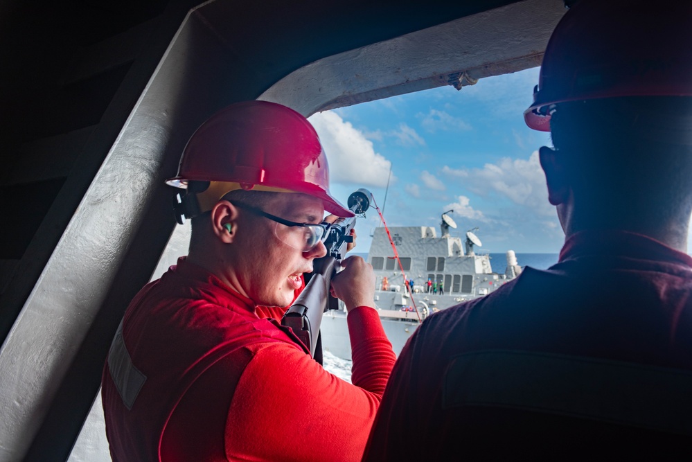 USS Ronald Reagan (CVN 76) conducts fueling-at-sea with USS Rafael Peralta (DDG 115)