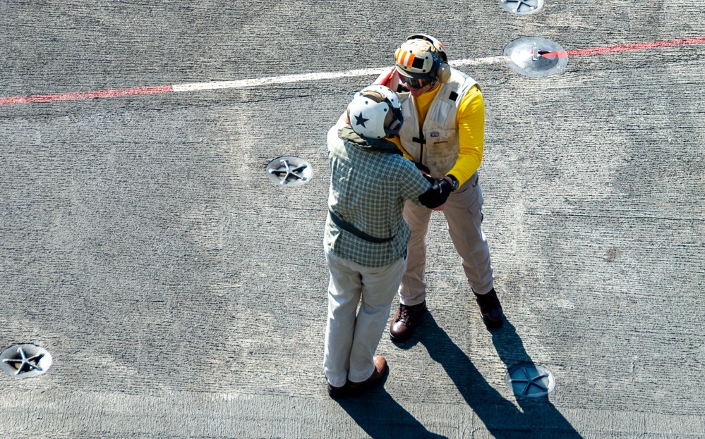 USS Ronald Reagan (CVN 76) Sailors render honors to Rear Adm. Buzz Donnelly