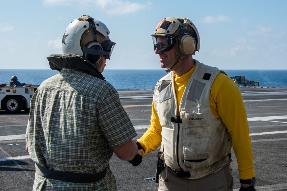 USS Ronald Reagan (CVN 76) Sailors render honors to Rear Adm. Buzz Donnelly