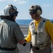 USS Ronald Reagan (CVN 76) Sailors render honors to Rear Adm. Buzz Donnelly