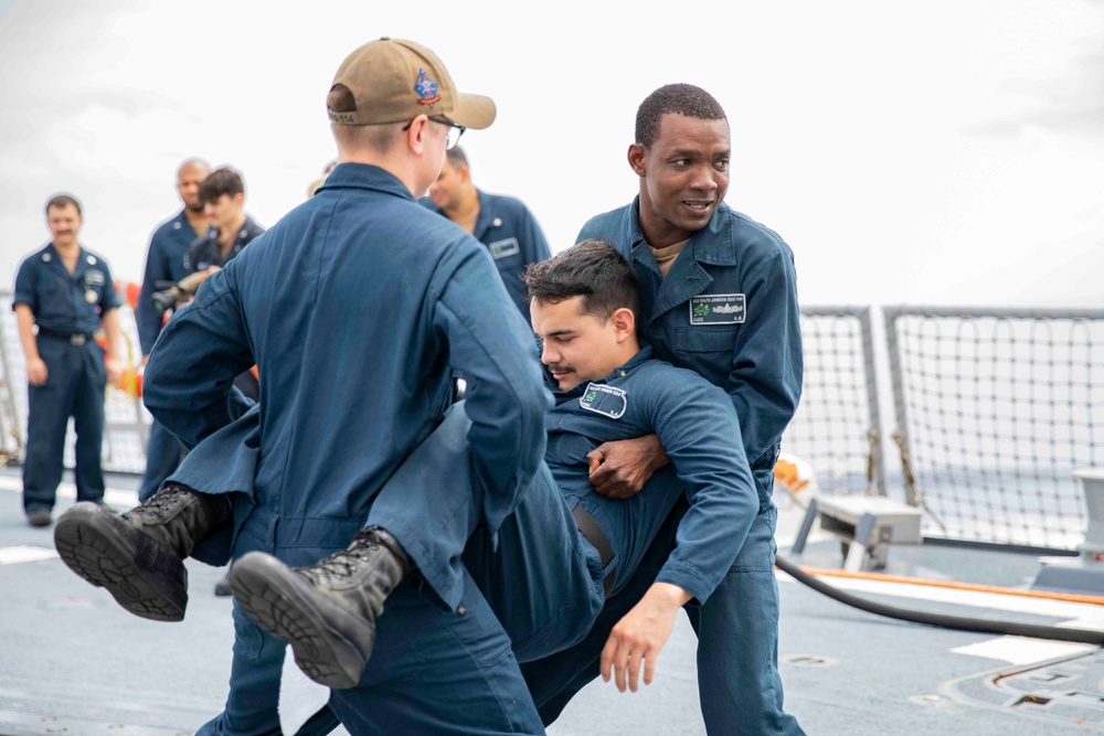 Sailors conduct simulated drills aboard USS Ralph Johnson (DDG 114), 27 June.