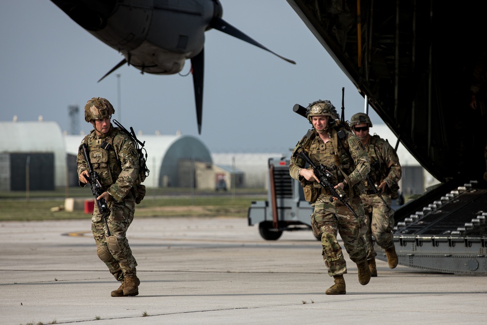 U.S. Army paratroopers pratice hooking up to the static line on Aviano Air  Base, Italy, before