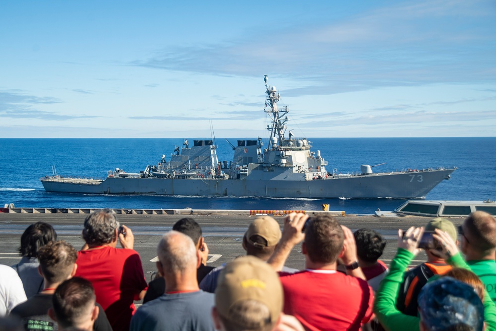 Destroyer Sails Alongside Carrier