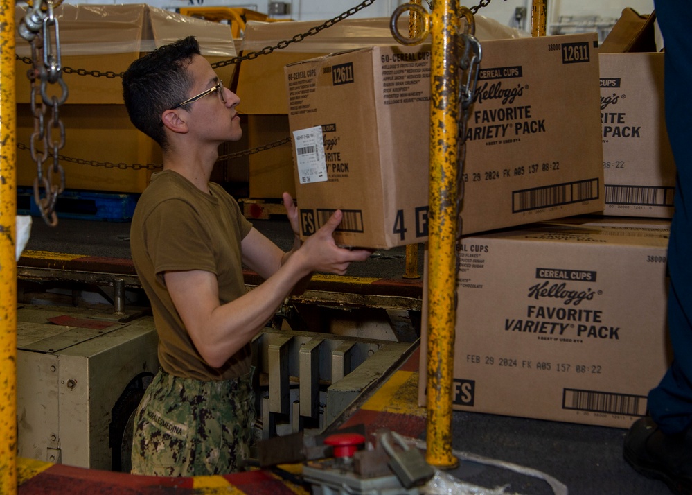 Sailor on-loads food aboard USS Carl Vinson (CVN 70)