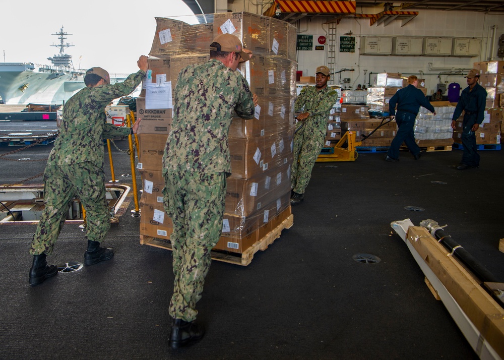 Sailors on-load food aboard USS Carl Vinson (CVN 70)