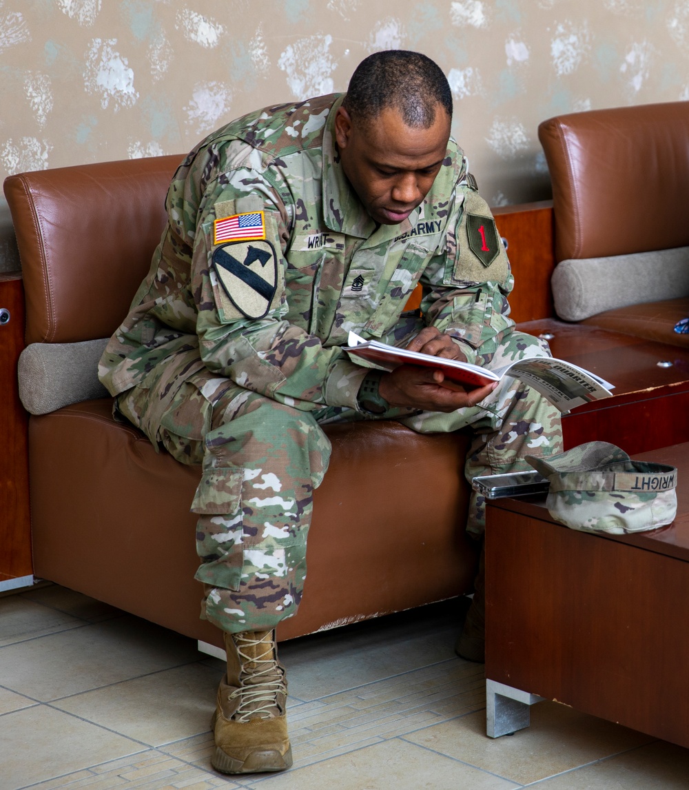 1st Infantry Division &quot;Danger Forward&quot; magazine gets read by Soldier