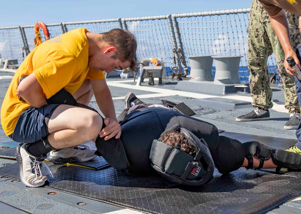 Sailors participate in an oleoresin capsicum (OC) course aboard USS Ralph Johnson (DDG 114), 28 June.