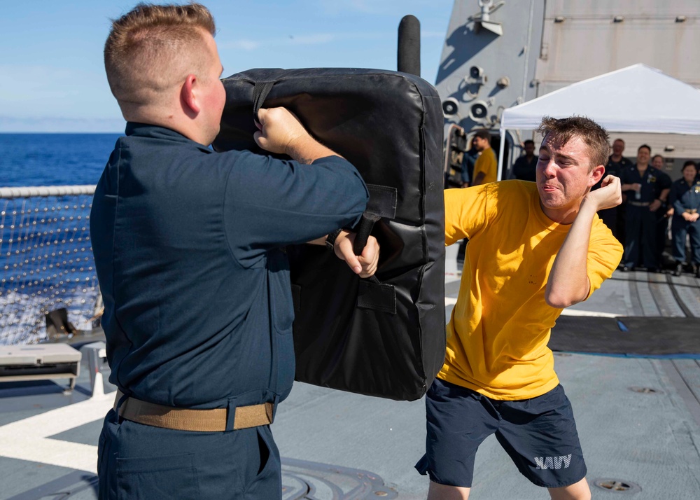 Sailors participate in an oleoresin capsicum (OC) course aboard USS Ralph Johnson (DDG 114), 28 June.