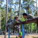Army Reserve 1st Lt. Jessica Romero, Air Force Reserve Col. Elizabeth Blanchford and Army Reserve Sgt. Christine Won complete an obstacle together