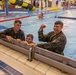 U.S. Air Force Reserve Maj. Sterling Broadhead, Norwegian Lt. Kristopher Smith and Dutch Lt. Erik Lammerts van Bueren complete the swim obstacle course