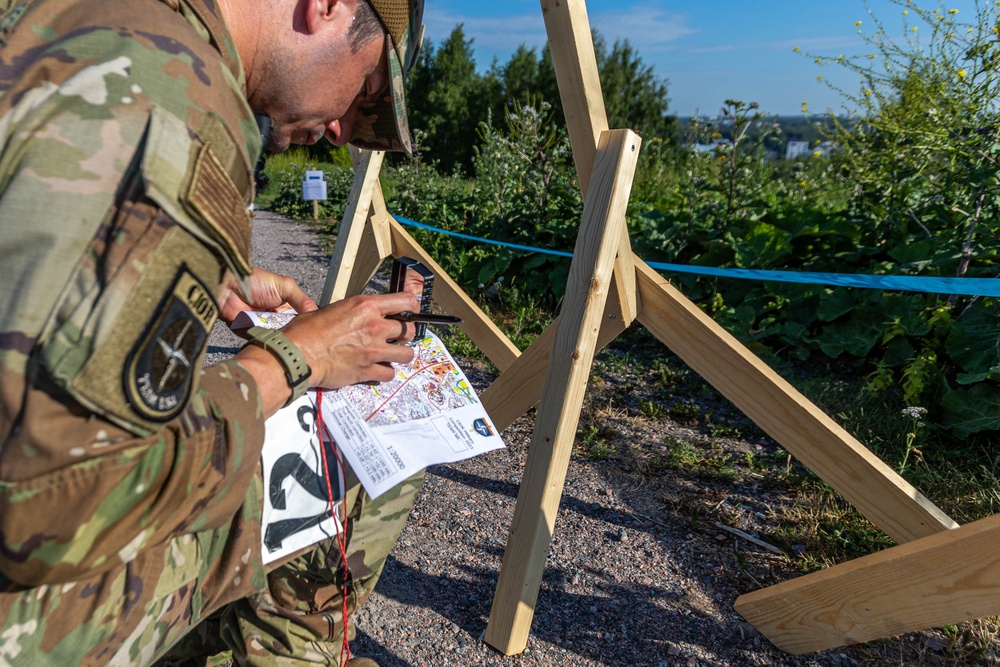 Air Force Reserve Maj. James Fink plots a point on his map