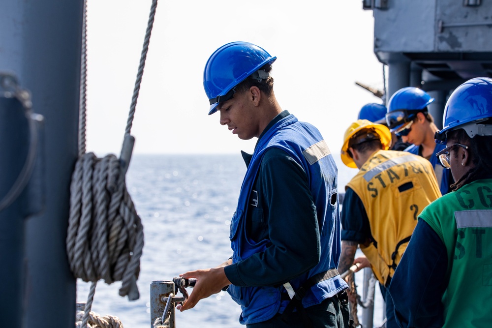 USS Robert Smalls (CG 62) Sailor Removes Life Lines before UNREP