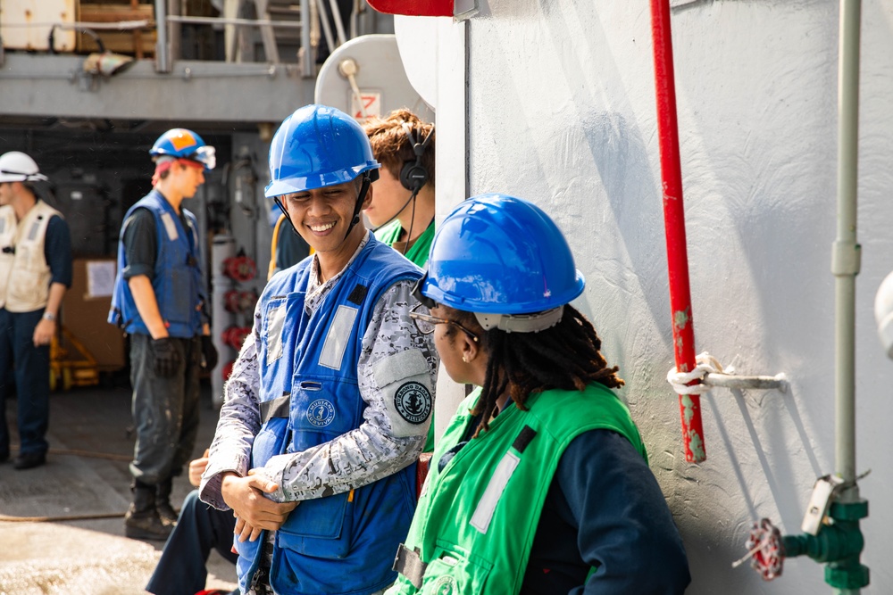 USS Robert Smalls (CG 62) Sailor Converses with Philippine Navy sailor during UNREP