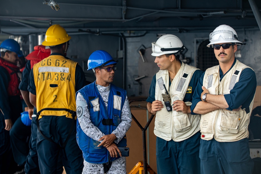 USS Robert Smalls (CG 62) Sailor converses with Philippine Navy sailor during UNREP