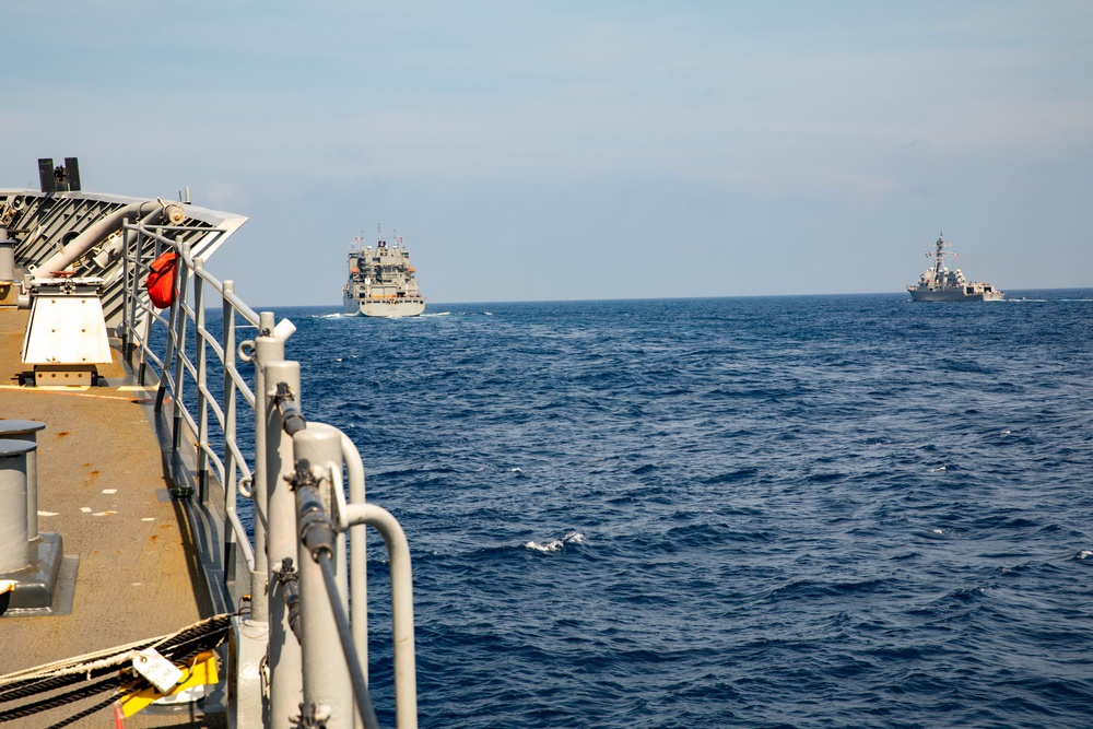 USS Robert Smalls (CG 62) Sails alongside USNS Carl Brashear (T-AKE 7) and USS Rafael Peralta (DDG 115)