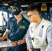 USS Robert Smalls (CG 62) Sailor discusses UNREP with Philippine Navy Sailor