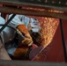 Contractor grinds metal onboard the USS John C. Stennis