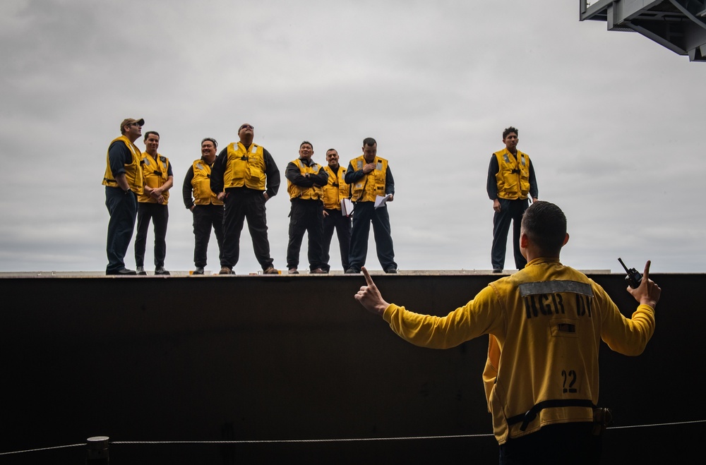 USS Theodore Roosevelt (CVN 71) Sailor perform a sprinkler check.