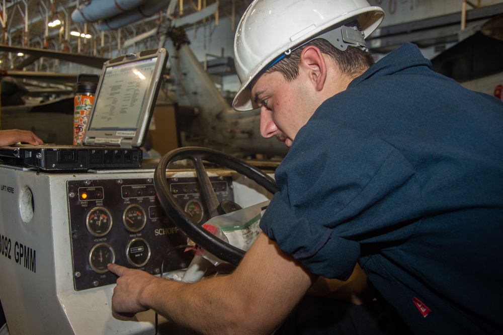 USS Ronald Reagan (CVN 76) Sailors maintain aircraft towing tractors