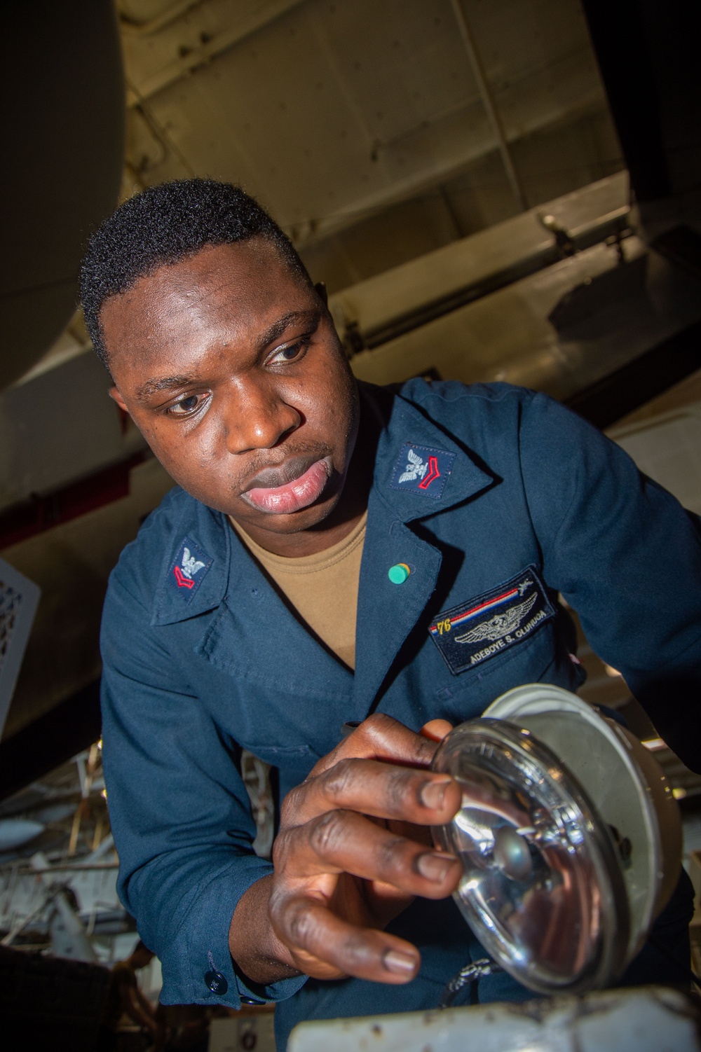 USS Ronald Reagan (CVN 76) Sailors maintain aircraft towing tractors