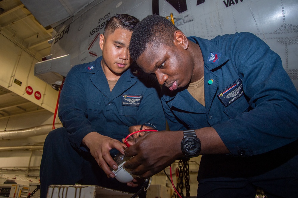 USS Ronald Reagan (CVN 76) Sailors maintain aircraft towing tractors