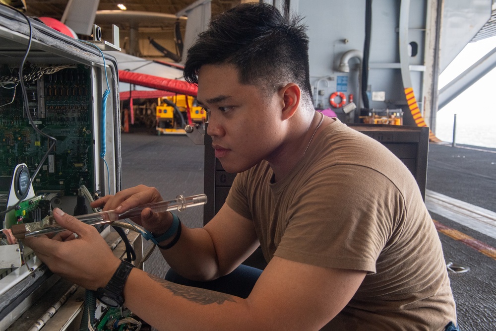 USS Ronald Reagan (CVN 76) Sailors maintain aircraft towing tractors