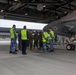 U.S Marines and Australian Airmen load CATM-120 Missiles together