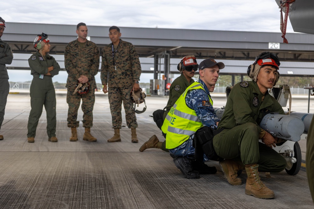 U.S Marines and Australian Airmen load CATM-120 Missiles together