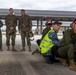 U.S Marines and Australian Airmen load CATM-120 Missiles together