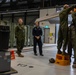 U.S Marines and Australian Airmen load CATM-120 Missiles together