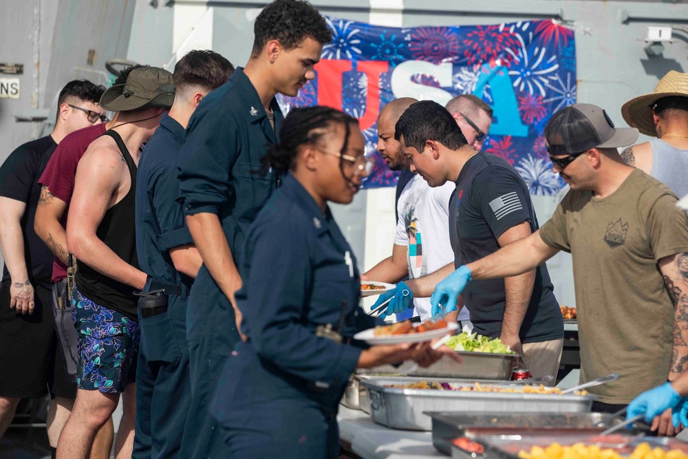 USS Ralph Johnson (DDG 114) Sailors enjoy a steel beach picnic on the ship’s flight deck to celebrate Independence Day in the Philippine Sea, July 4.