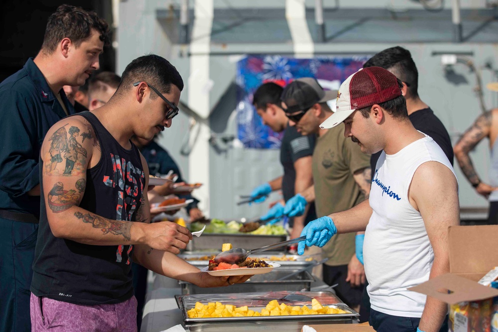 USS Ralph Johnson (DDG 114) Sailors enjoy a steel beach picnic on the ship’s flight deck to celebrate Independence Day in the Philippine Sea, July 4.