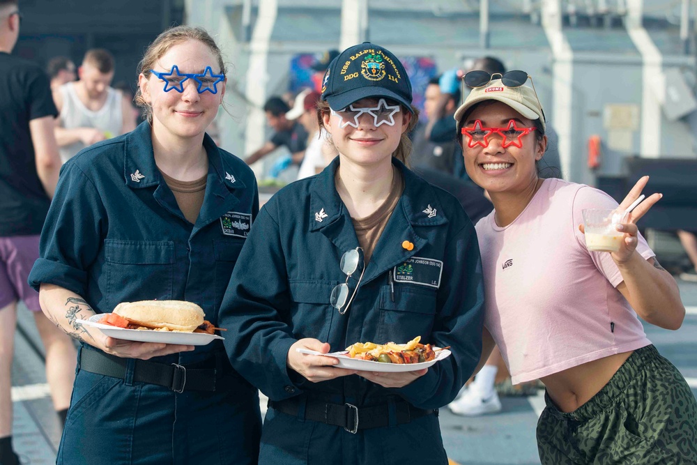 USS Ralph Johnson (DDG 114) Sailors enjoy a steel beach picnic on the ship’s flight deck to celebrate Independence Day in the Philippine Sea, July 4.