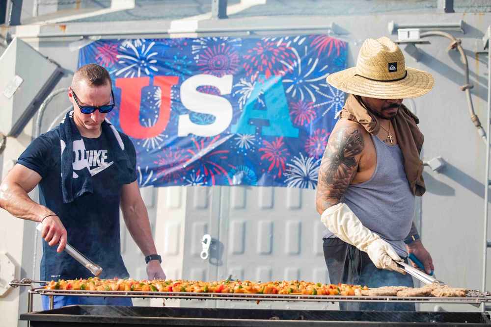 USS Ralph Johnson (DDG 114) Sailors enjoy a steel beach picnic on the ship’s flight deck to celebrate Independence Day in the Philippine Sea, July 4.