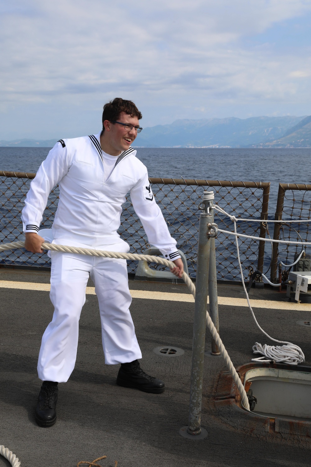 Sailor Pulls Up Mooring Line