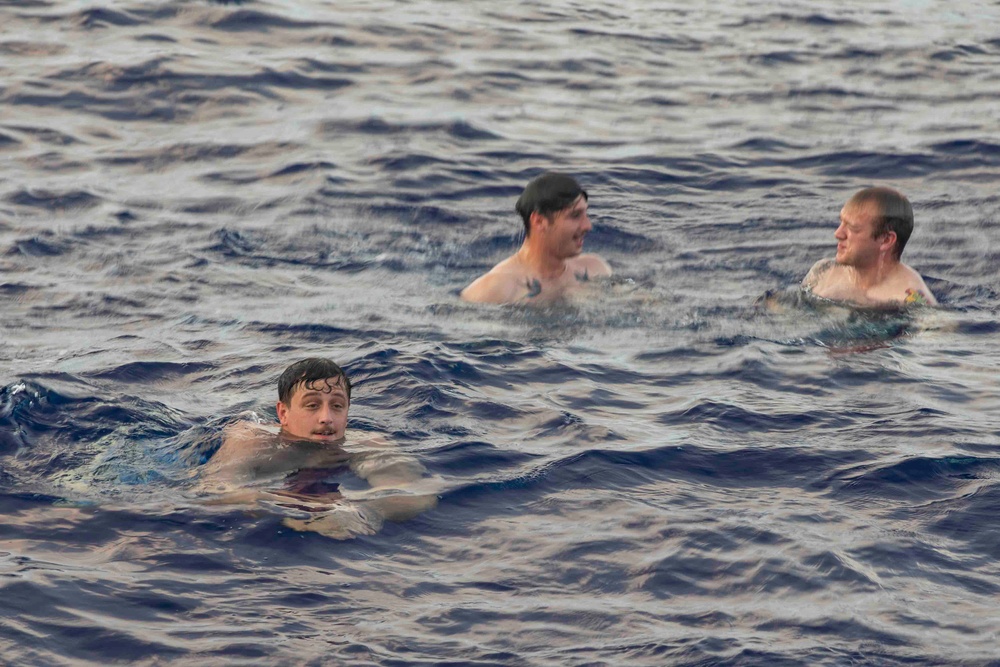 USS Ralph Johnson (DDG 114) Sailors enjoy swim call in the Philippine Sea, July 4