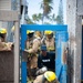 Firefighter recruits participate in firefighting drills