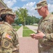 CSM Allen receives a command coin from BG Shirley