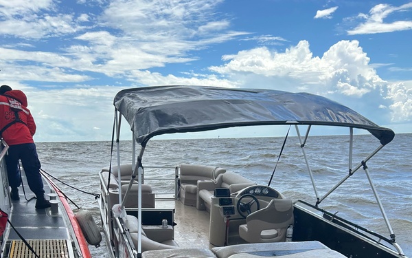 Coast Guard 45-foot Response Boast-Medium next to pontoon boat in Lake Pontchartrain, Louisiana 