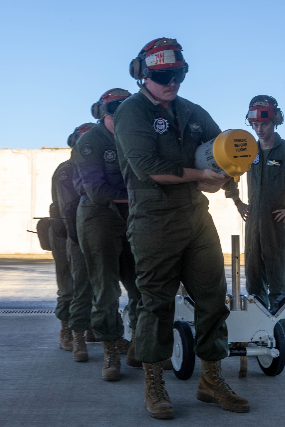 U.S. Marines and Australian Airmen load Missiles on Joint Strike Fighters together  