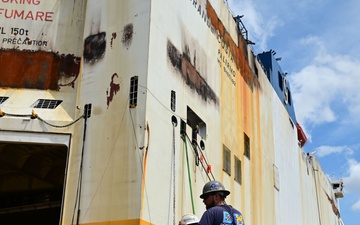 Responders conduct dewatering on the Grande Costa D'Avorio following vessel fire