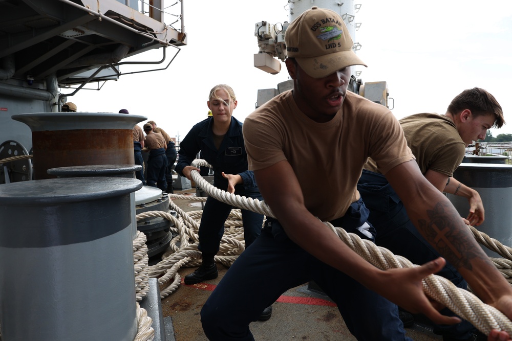 Bataan Sailors heave mooring lines