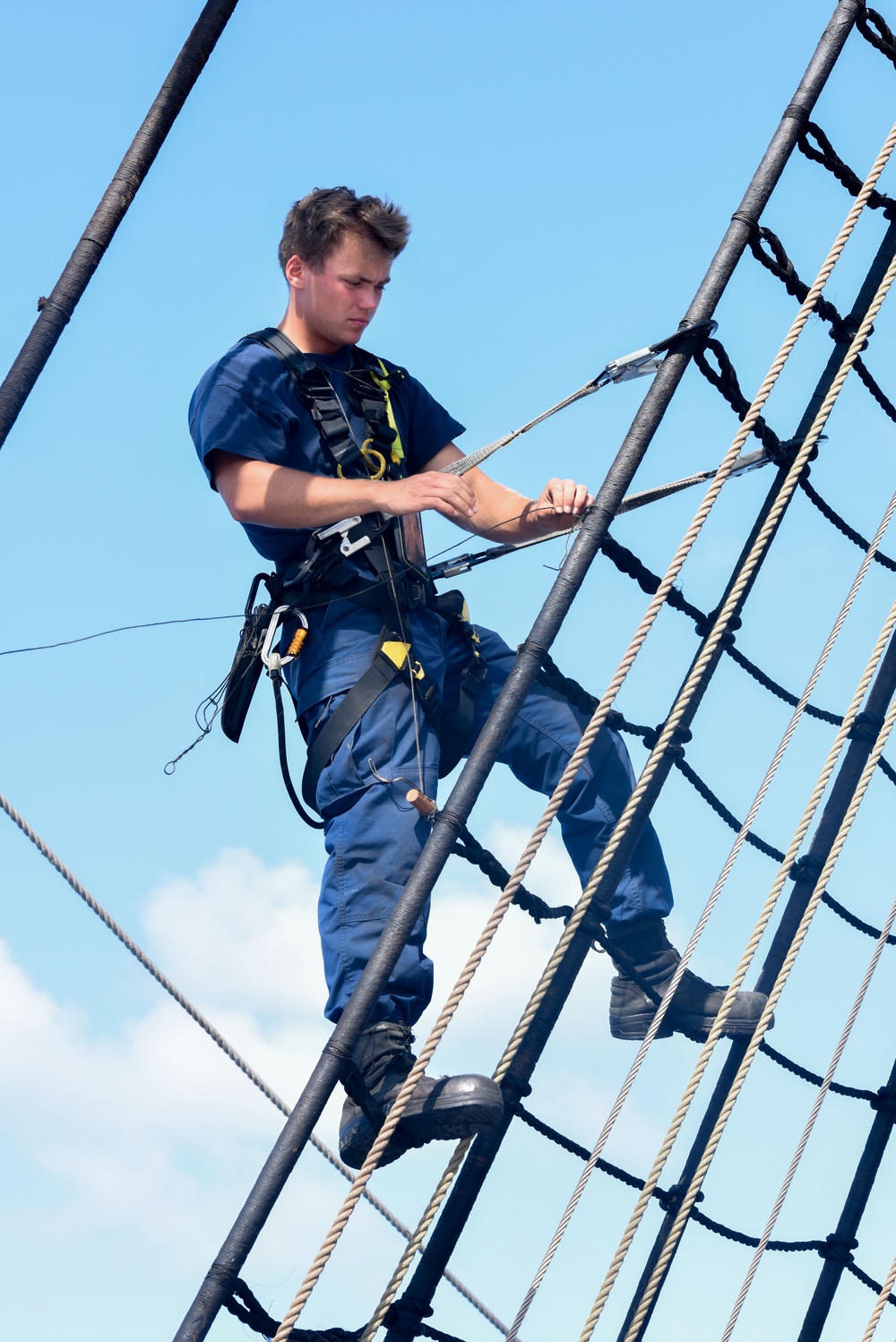 USCGC Eagle crewmember climbs foremast