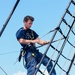 USCGC Eagle crewmember climbs foremast