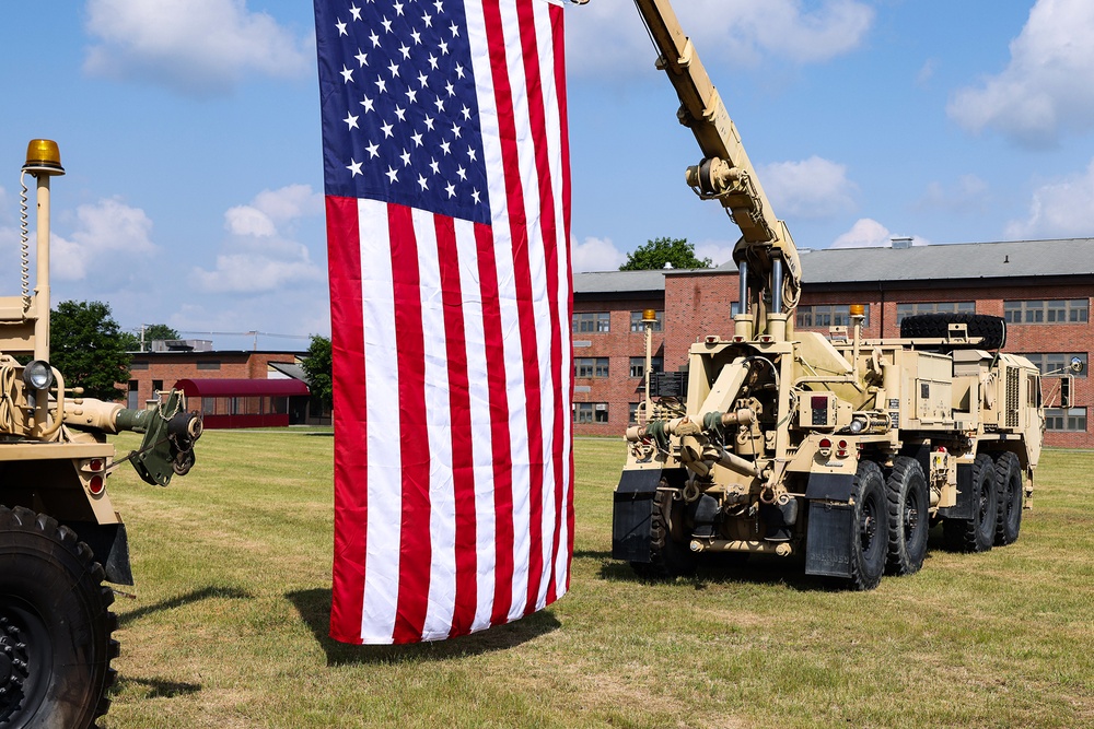 Military vehicles from the 94th Training Division hoist the American flag for the Change of Command Ceremony