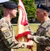 LTC Trent Colestock, outgoing Garrison Commander, passes the Garrison colors to the presiding officer, Col Mitchell Wisniewski