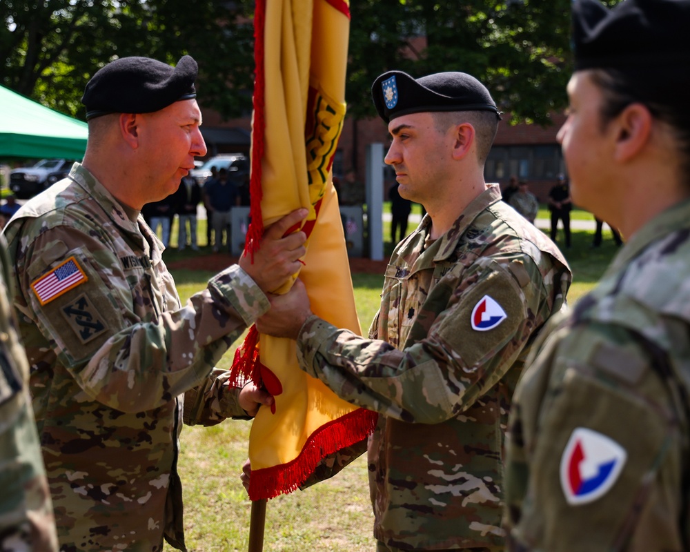 Col Mitchell Wisniewski, the presiding officer, passes the Garrison colors to incoming Garrison Commander, LTC Joshua Bloom