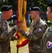 Col Mitchell Wisniewski, the presiding officer, passes the Garrison colors to incoming Garrison Commander, LTC Joshua Bloom