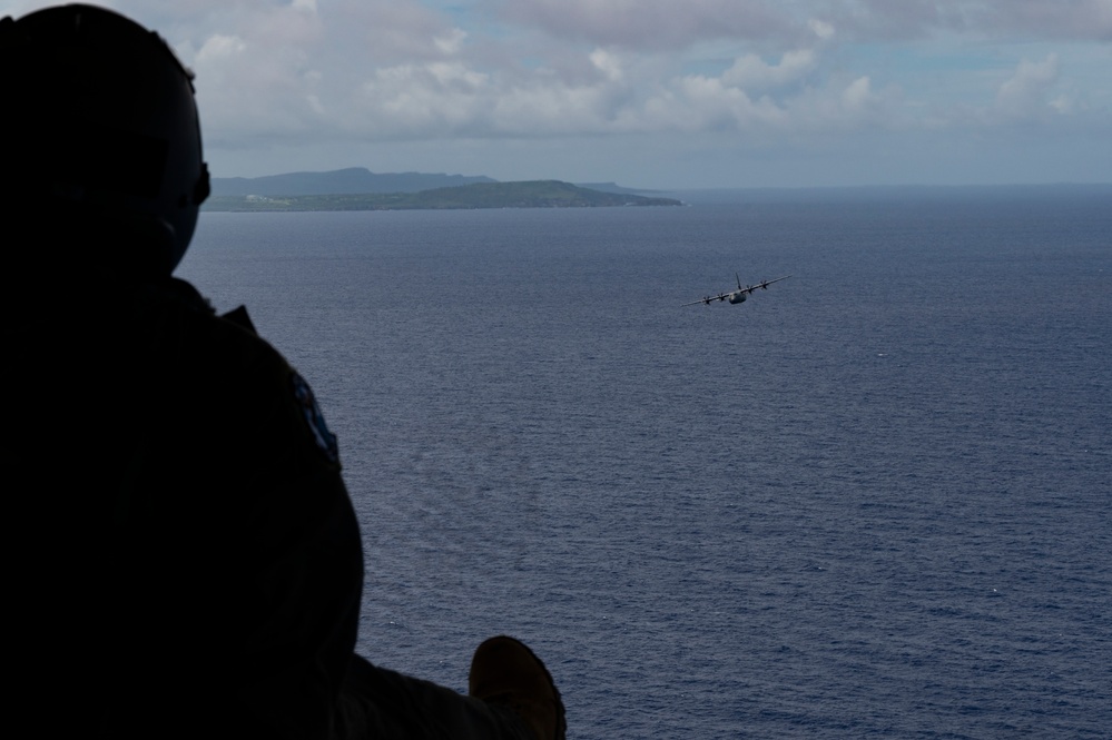 MG23: 61st AS flies above Tinian