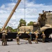 U.S. Army Soldiers of the 25th Combat Aviation Brigade coordinate to reassemble the rotor blades on a CH-47 Chinook helicopter